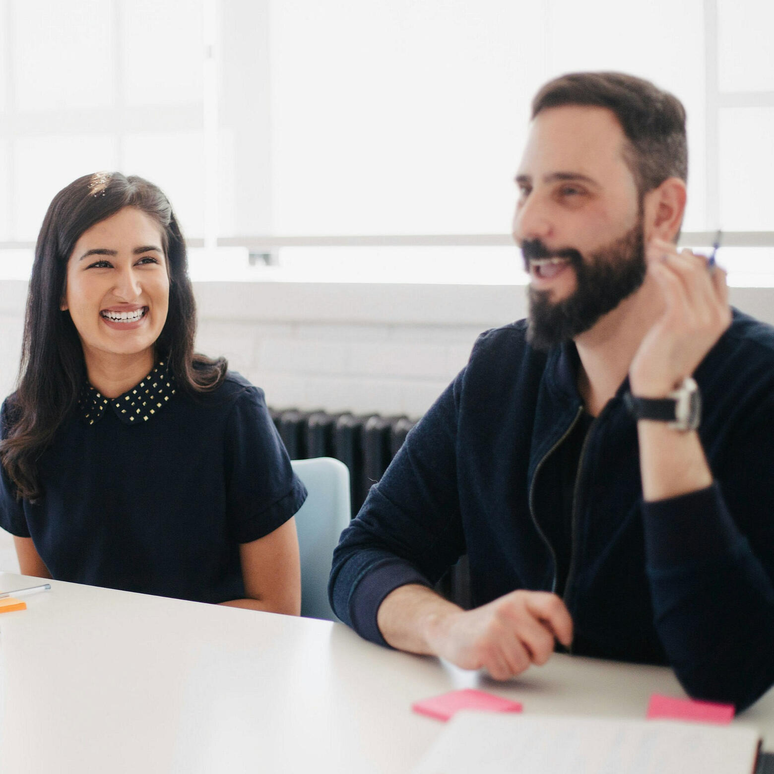 A woman sitting looking bored