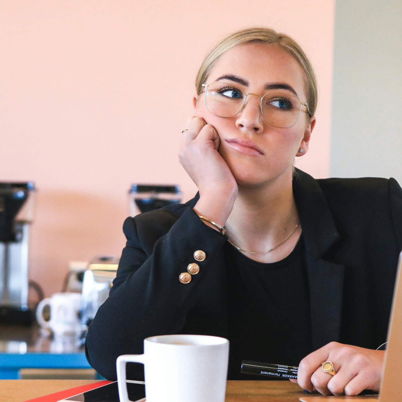 A woman sitting looking bored